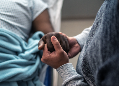 Someone holding a patients hand