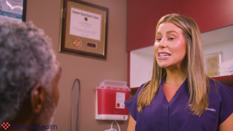 Healthcare professional explaining heart failure diagnosis and treatment options to an elderly patient in a clinic.